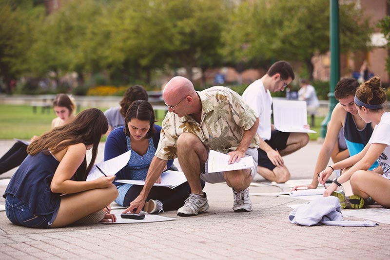 Teaching class on College's quad.