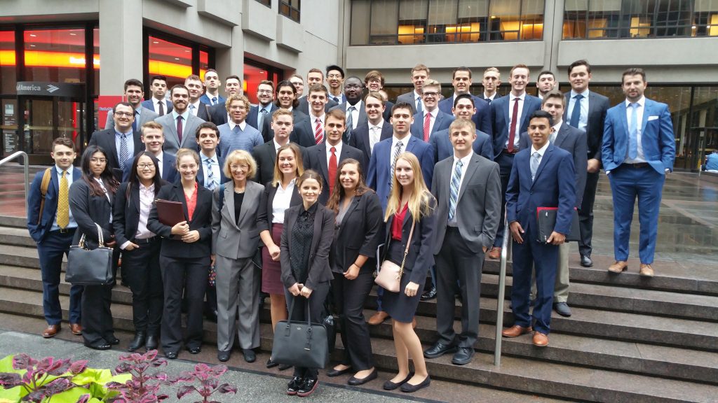 School of Business students and faculty on the steps of a firm in NY.