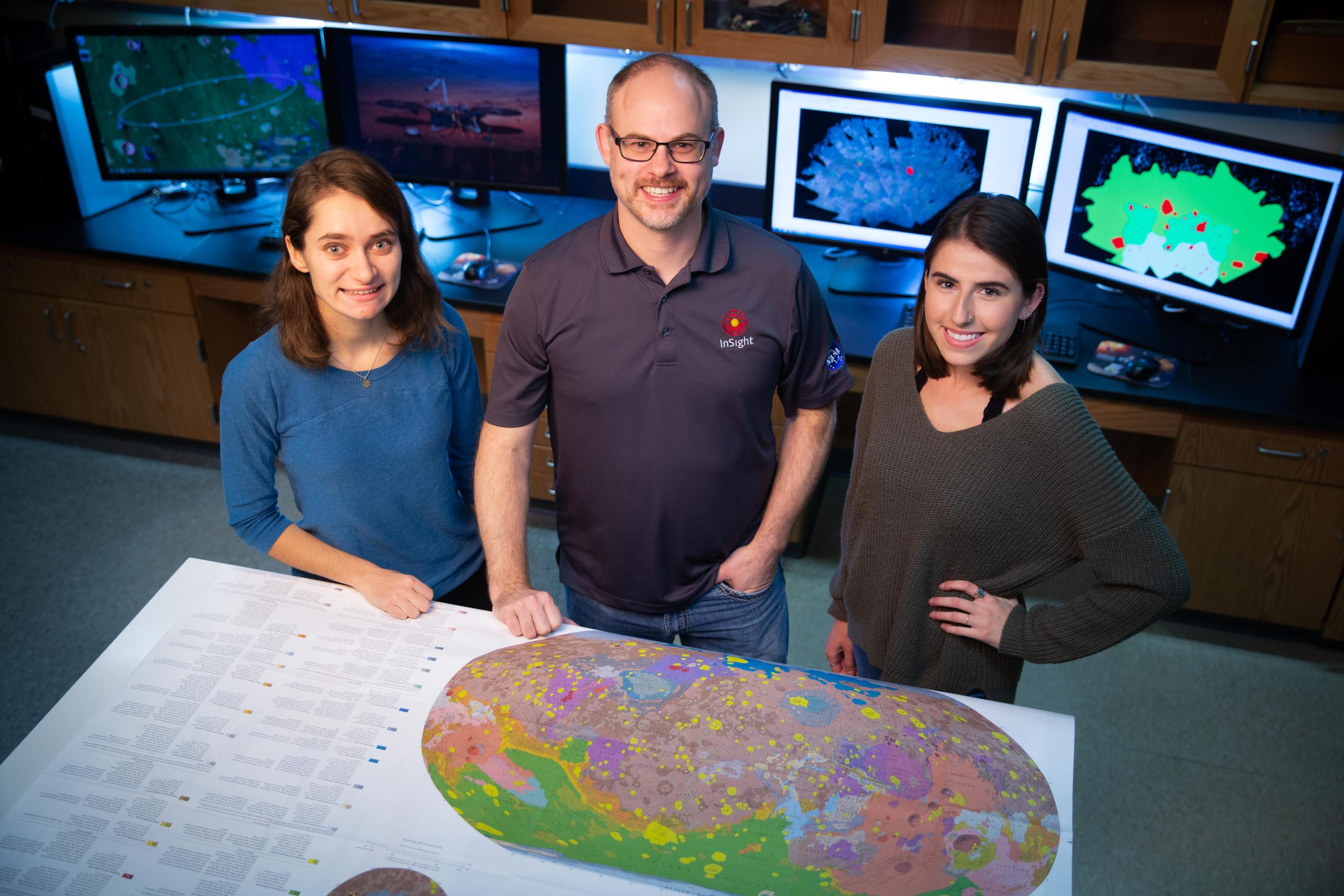 Student and professor looking at maps of Mars