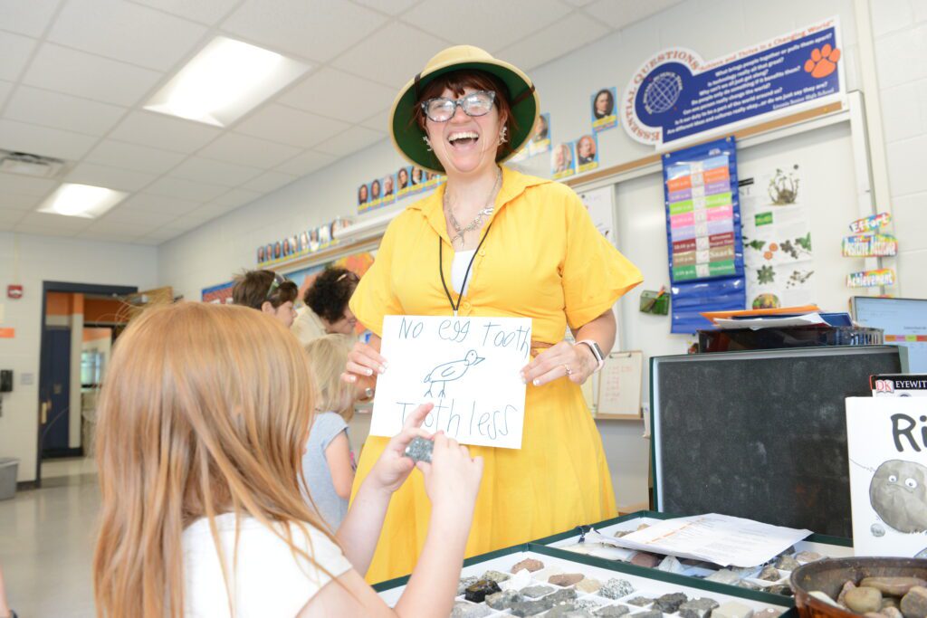 Sarah Hill Stone '12/MSEd '16 works with a student in a classroom.