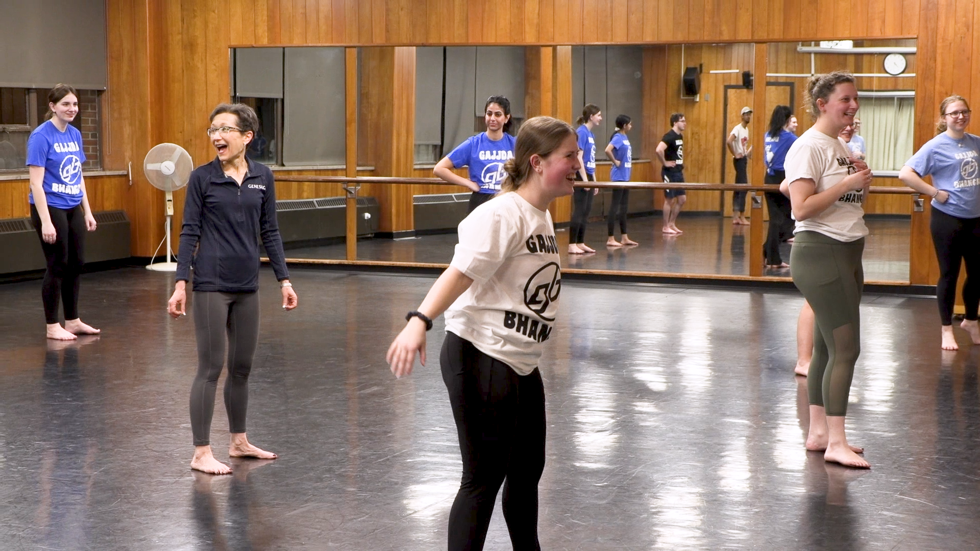 President Denise A. Battles practices with the Bhangra dance crew in a dance studio