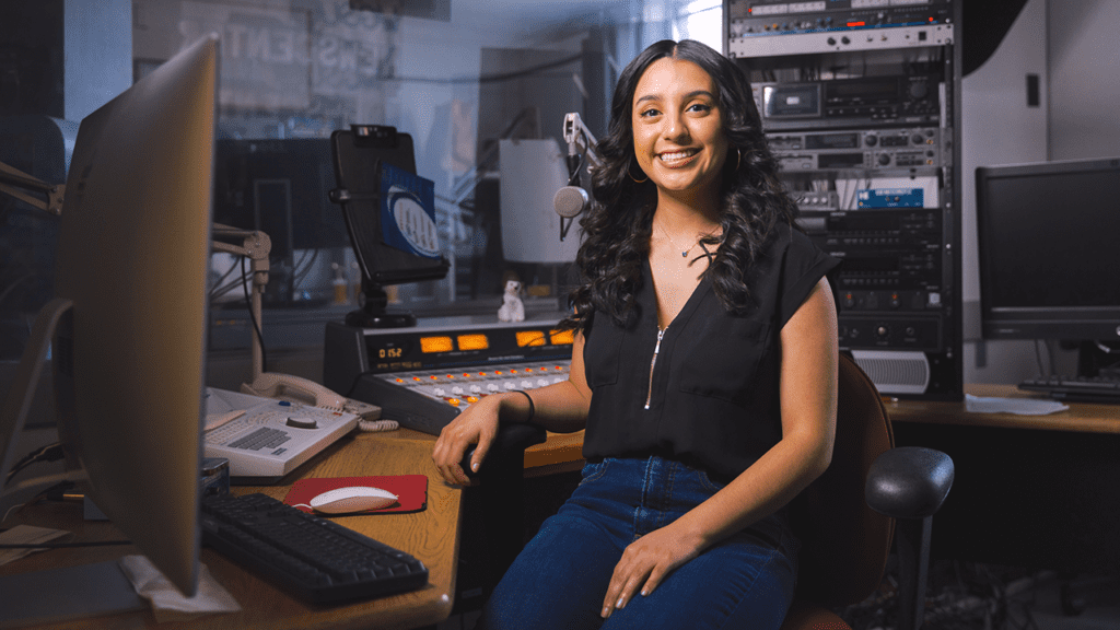 Student in radio station production room
