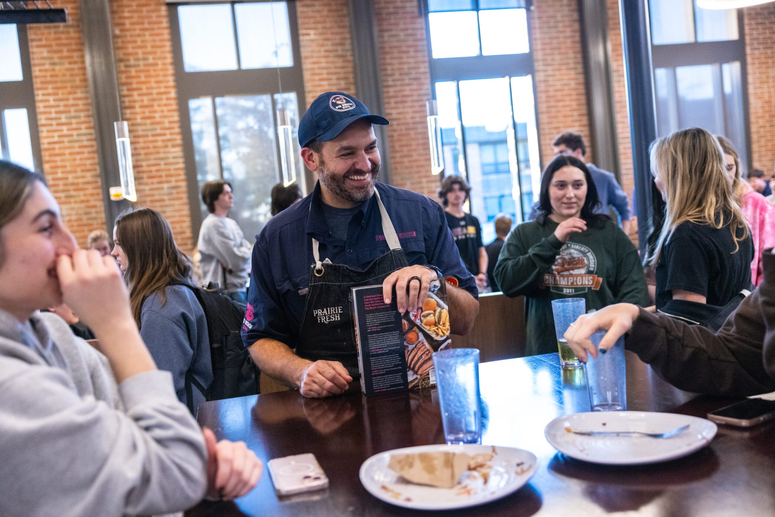 Matt Abdoo '02 talks with students during a dinner service on campus.