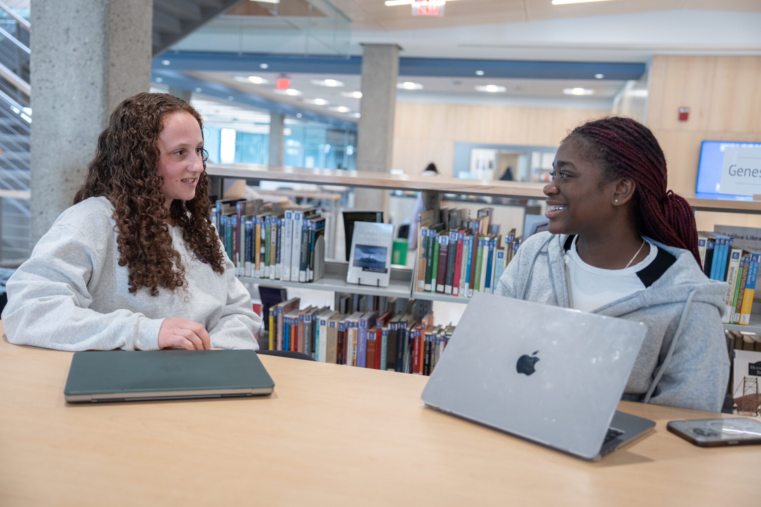 Hannah%2BRahara_MB2_04302025 BIOME mentor Hannah Tomasulo '27, left, meets with Rahara Simon '28 in Milne Library. (SUNY Geneseo/Matt Burkhartt)