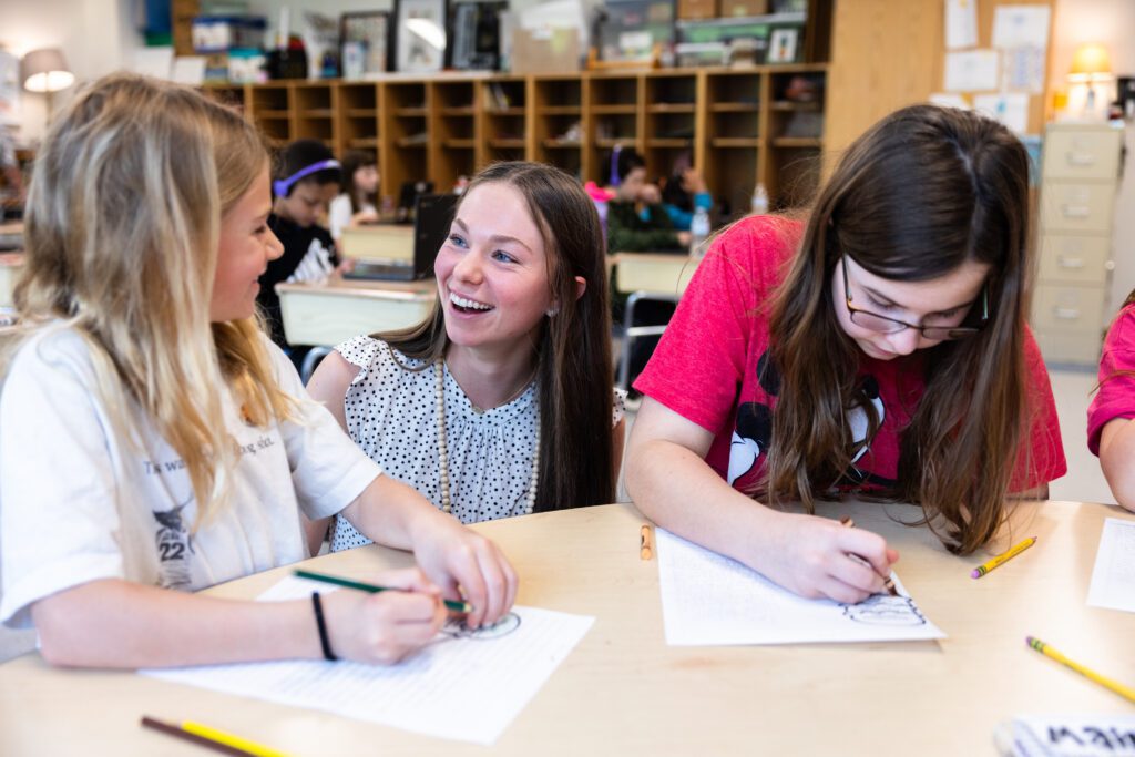 Taylor Maddy '24 speaks with elementary students while completing a lesson.