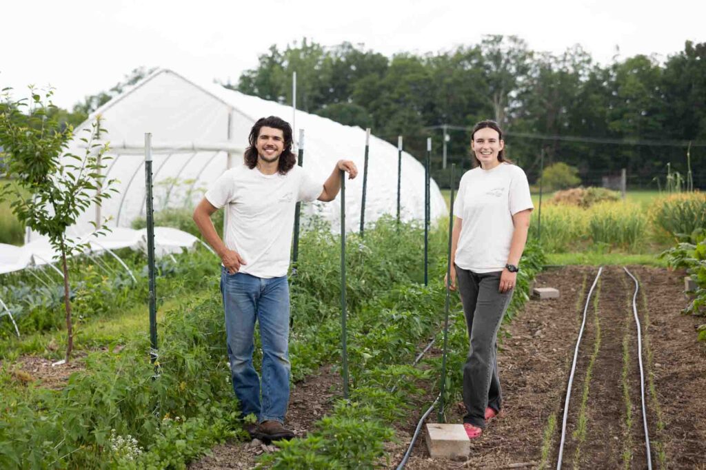 Sean Perry and Bari Zeiger standing in front of garden beds.