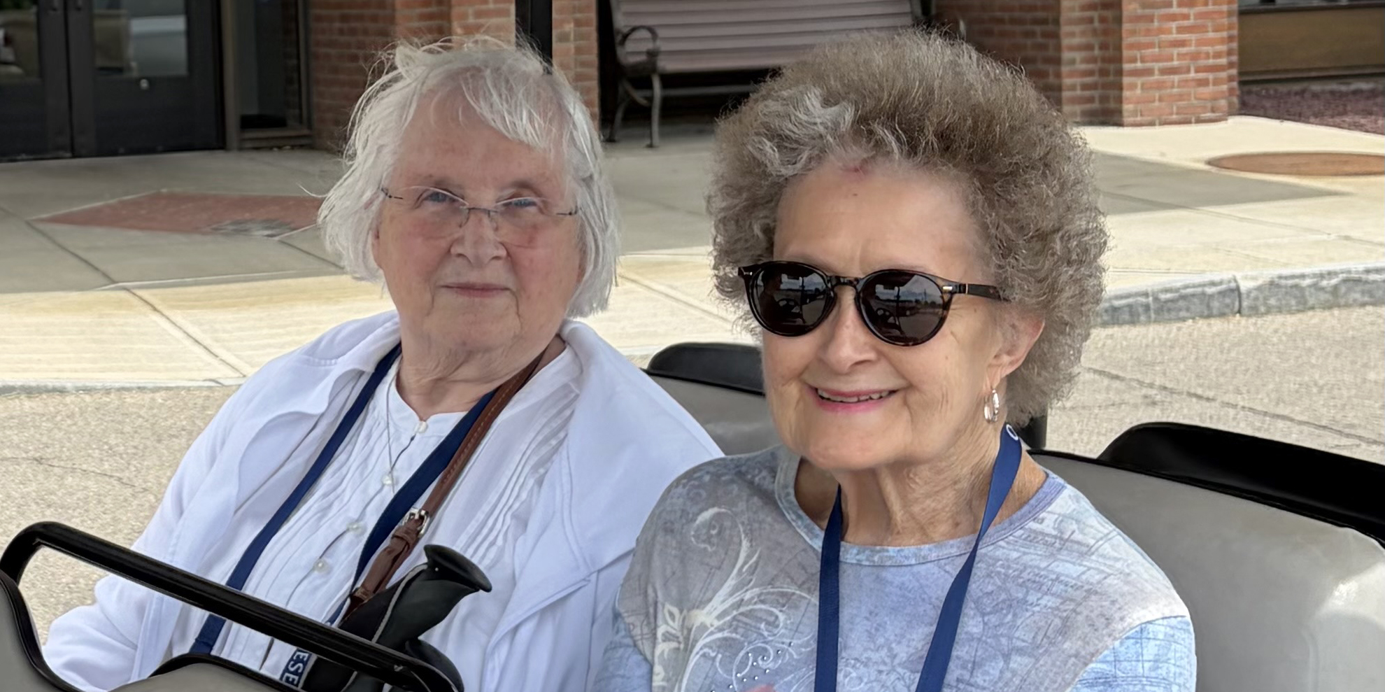 Karen Davis and Gerry Wilson, Class of 1966, on a golf cart tour of campus