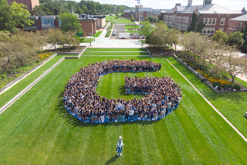 Students form the letter 