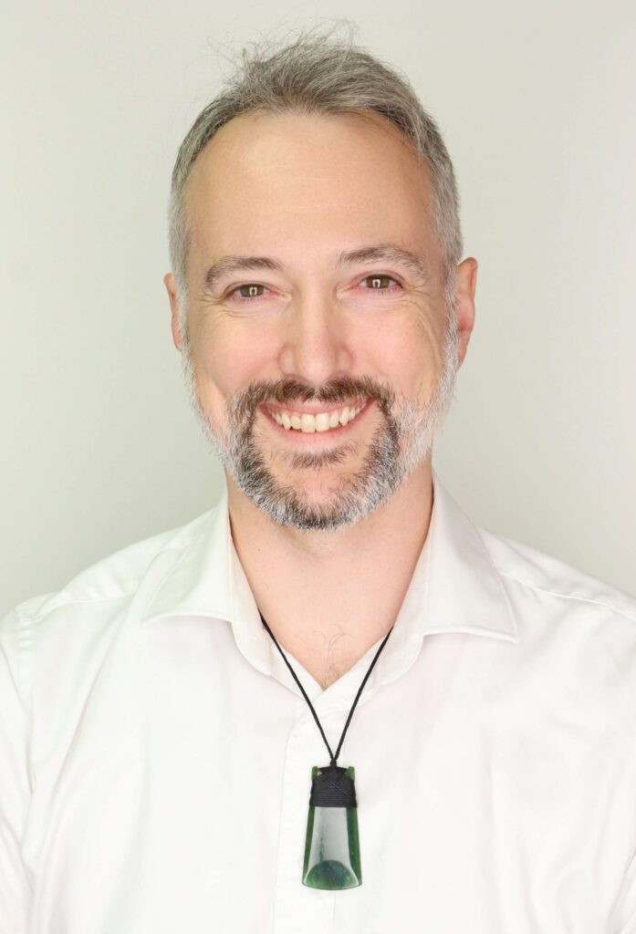 Photo of man that is affable and a bit goofy looking, but also maybe like he knows what he's talking about.