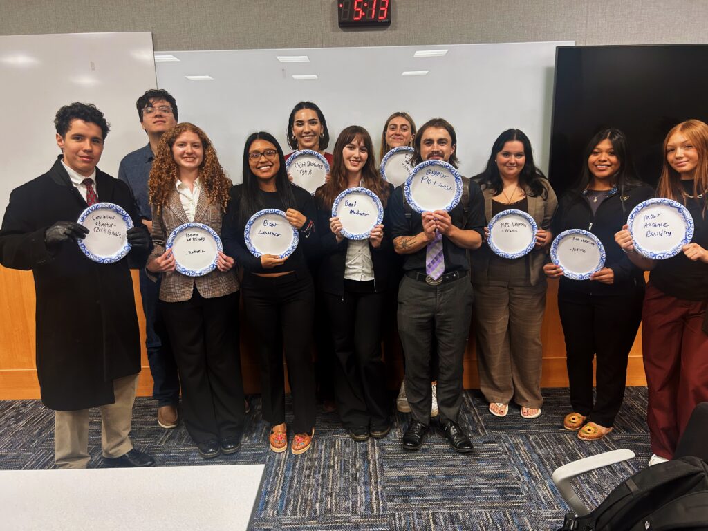 Students from Model UN Club hold signs of their delegations.